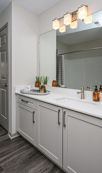 a white bathroom with two sinks and a mirror at Ashford Green, Charlotte